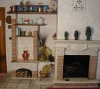 Fireplace and wall in cotto and travertine